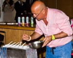 Zimmern adding chopped onions to the amuse bouche of clam.
